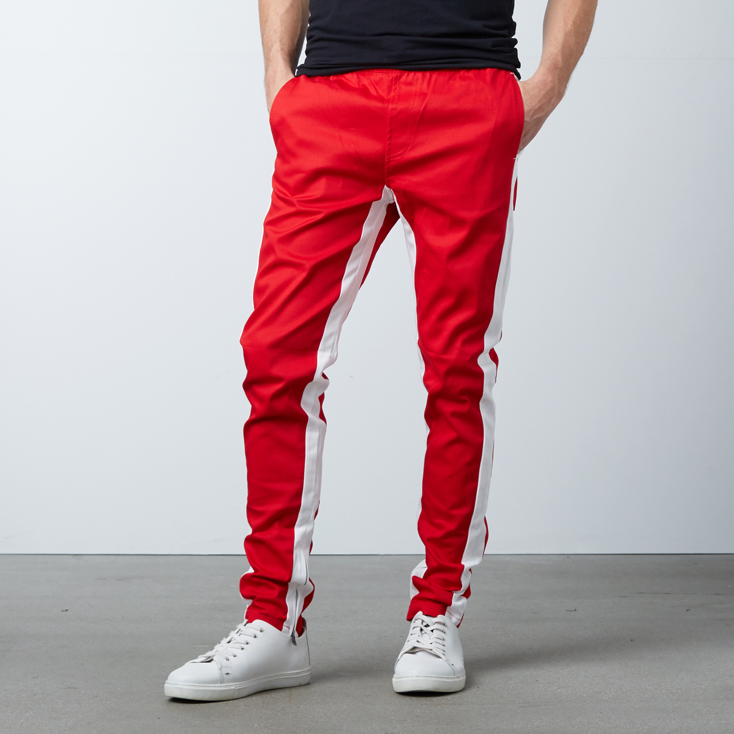 red track pants with white stripe