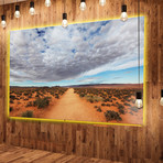 Desert Road Under Bright Cloudy Sky