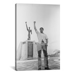 Muhammad Ali Posing In Front Of The Le Militant Statue, Kinshasa, Zaire // Muhammad Ali Enterprises (12"W x 18"H x 0.75"D)