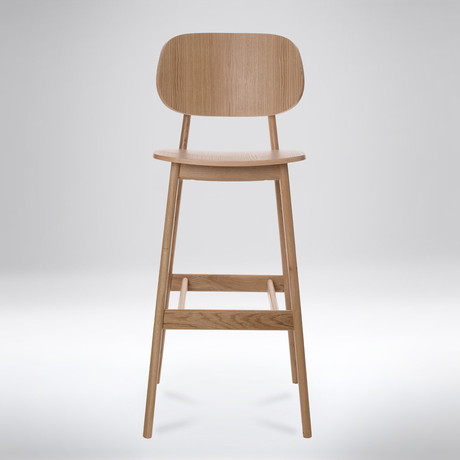 Sleek and simple, the Elise Bar Stool is a natural oak wood chair that adds...