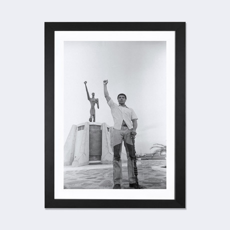 Muhammad Ali Posing In Front Of The Le Militant Statue // Muhammad Ali Enterprises (24"W x 16"H x 1"D)