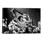 Sylvester Stallone Carried By A Men And Holding A Flag (18"W x 26"H x 0.75"D)