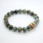 African Turquoise Bead Bracelet // Brass Logo Bead