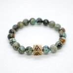 African Turquoise Bead Bracelet // Brass Logo Bead