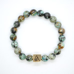 African Turquoise Bead Bracelet // Brass Logo Bead