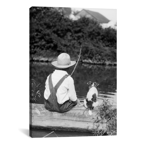 1920s-1930s Farm Boy Wearing Straw Hat And Overalls Sitting (18"W x 26"H x 0.75"D)