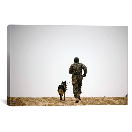 A Dog Handler And His Military Working Dog Take A Brisk Walk by Stocktrek Images (26"W x 18"H x 0.75"D)