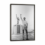 Muhammad Ali Posing In Front Of The Le Militant Statue, Kinshasa, Zaire by Muhammad Ali Enterprises (26"H x 18"W x 0.75"D)