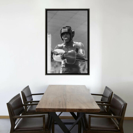 Head Gear Wearing Muhammad Ali In The Corner Between Rounds by Muhammad Ali Enterprises (26"H x 18"W x 0.75"D)