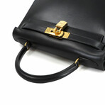 Hermès // Box Calf Leather Kelly 28 Handbag // Black + Gold // Pre-Owned